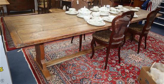 A large pine plank top refectory dining table 305 x 96cm